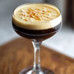 Homemade espresso martini recipe served in a coupe glass with creamy foam, caramel drizzle, and a light dusting of sea salt.