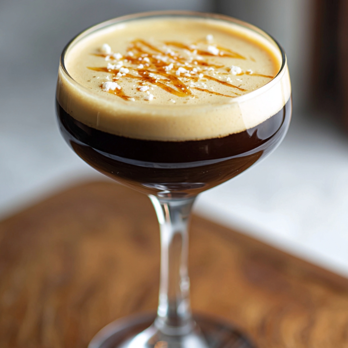 Homemade espresso martini recipe served in a coupe glass with creamy foam, caramel drizzle, and a light dusting of sea salt.