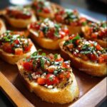 Golden toasted Bruschetta recipe slices topped with diced fresh tomatoes, basil, garlic, and a drizzle of olive oil for classic Italian bruschetta.