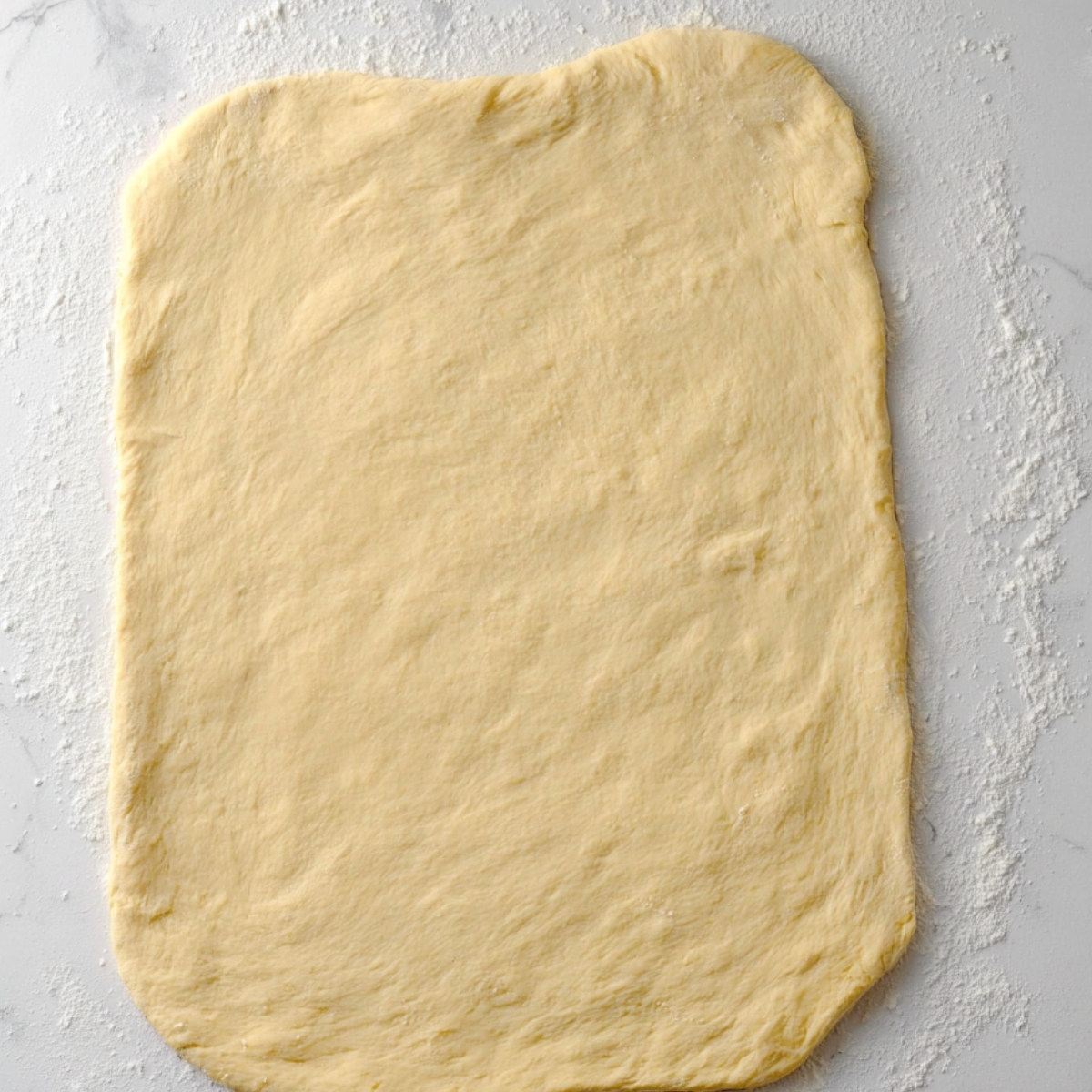 “Rolled-out dough on a lightly floured surface.”