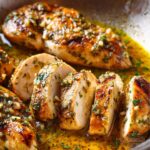 “Sliced garlic butter chicken breasts in a skillet.”