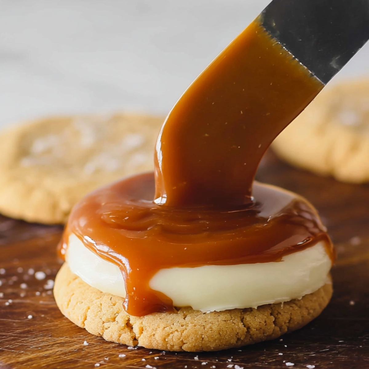 Here’s the caramel being poured over the cheesecake layer on top of the cookie! It’s coming together beautifully