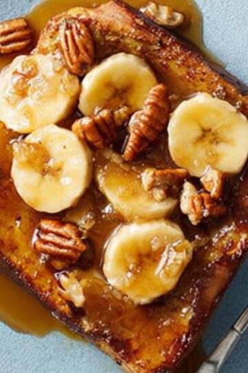 Bananas Foster French Toast topped with caramelized bananas and pecans.