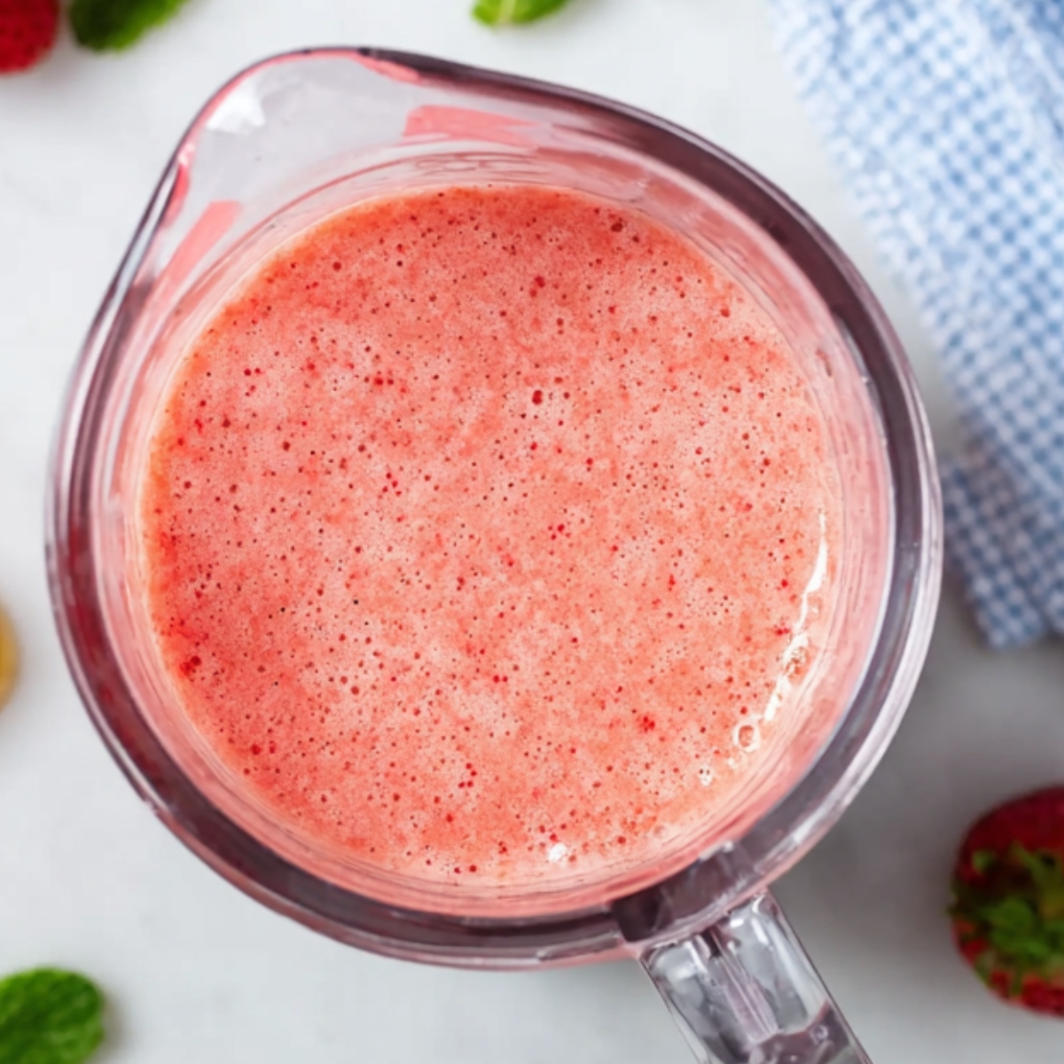 Fresh strawberry watermelon smoothie blended until smooth in a blender.