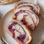 Slices of blueberry cream cheese babka with a soft, airy texture and a swirl of berry filling.