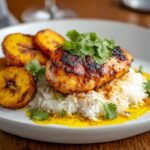 Churu Chicken Amarillo served over rice with fried plantains.