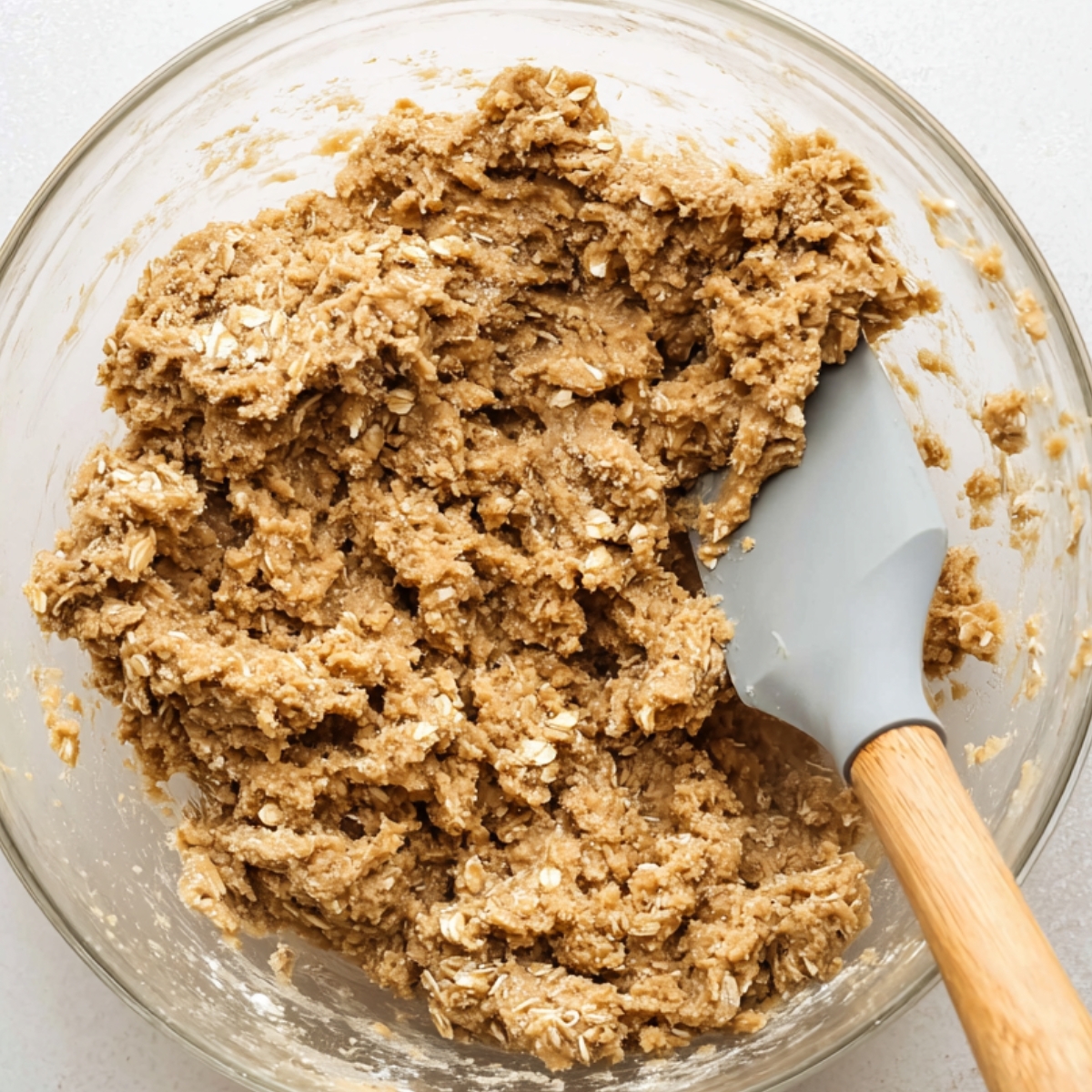 Oatmeal cookie dough mixed in a bowl.