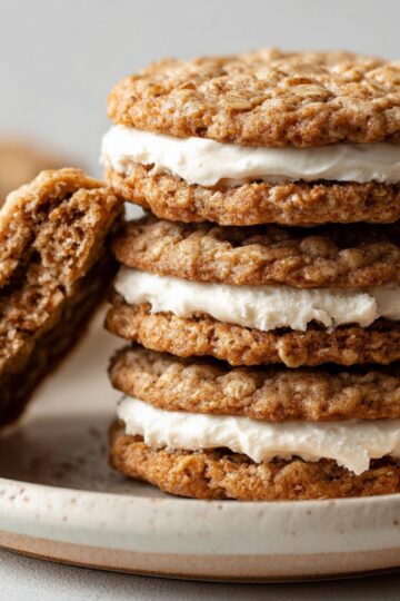 Homemade Oatmeal Cream Pies stacked on a plate.