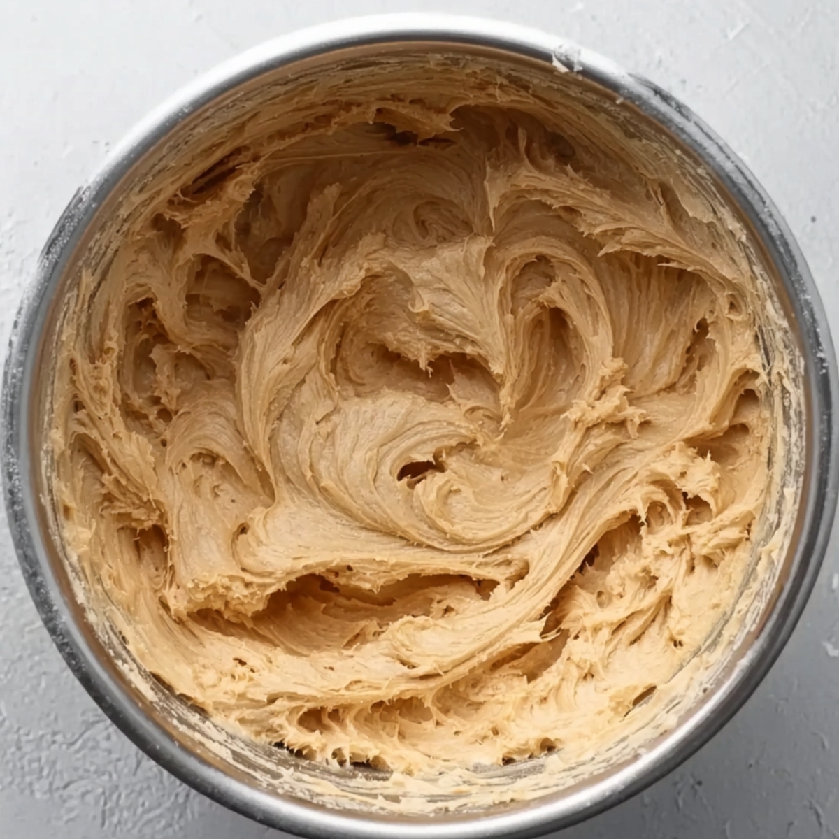 A creamy, smooth mixture of Biscoff and cream cheese in a bowl.