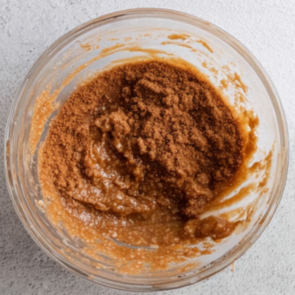 A mixture of cinnamon and sugar combined in a bowl.