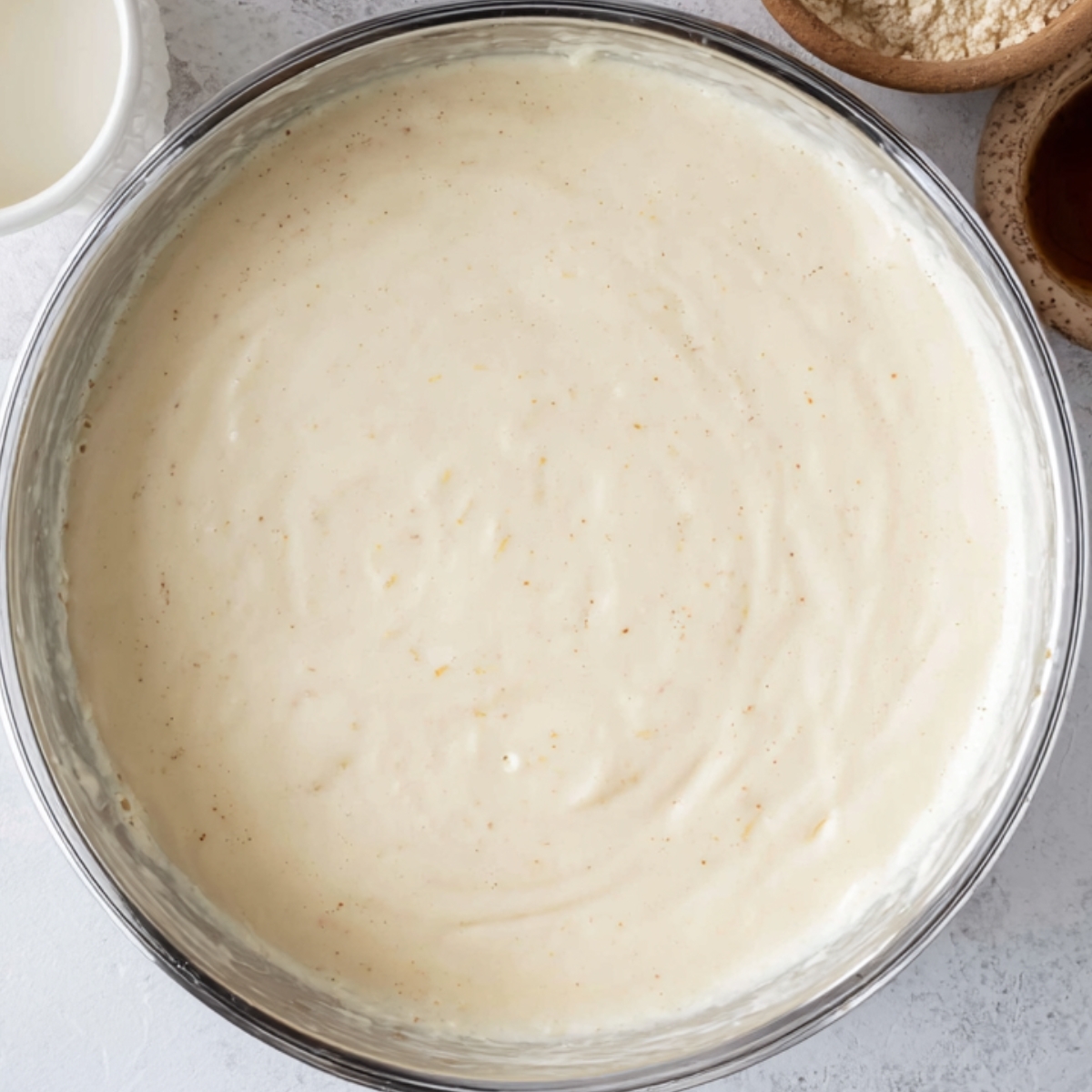 A smooth pancake batter in a mixing bowl, ready to cook.