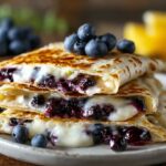 Delicious blueberry breakfast quesadillas with melted cheese and fresh blueberries on top.