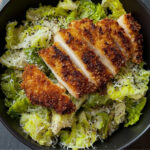 crispy hot honey chicken over chopped lettuce salad