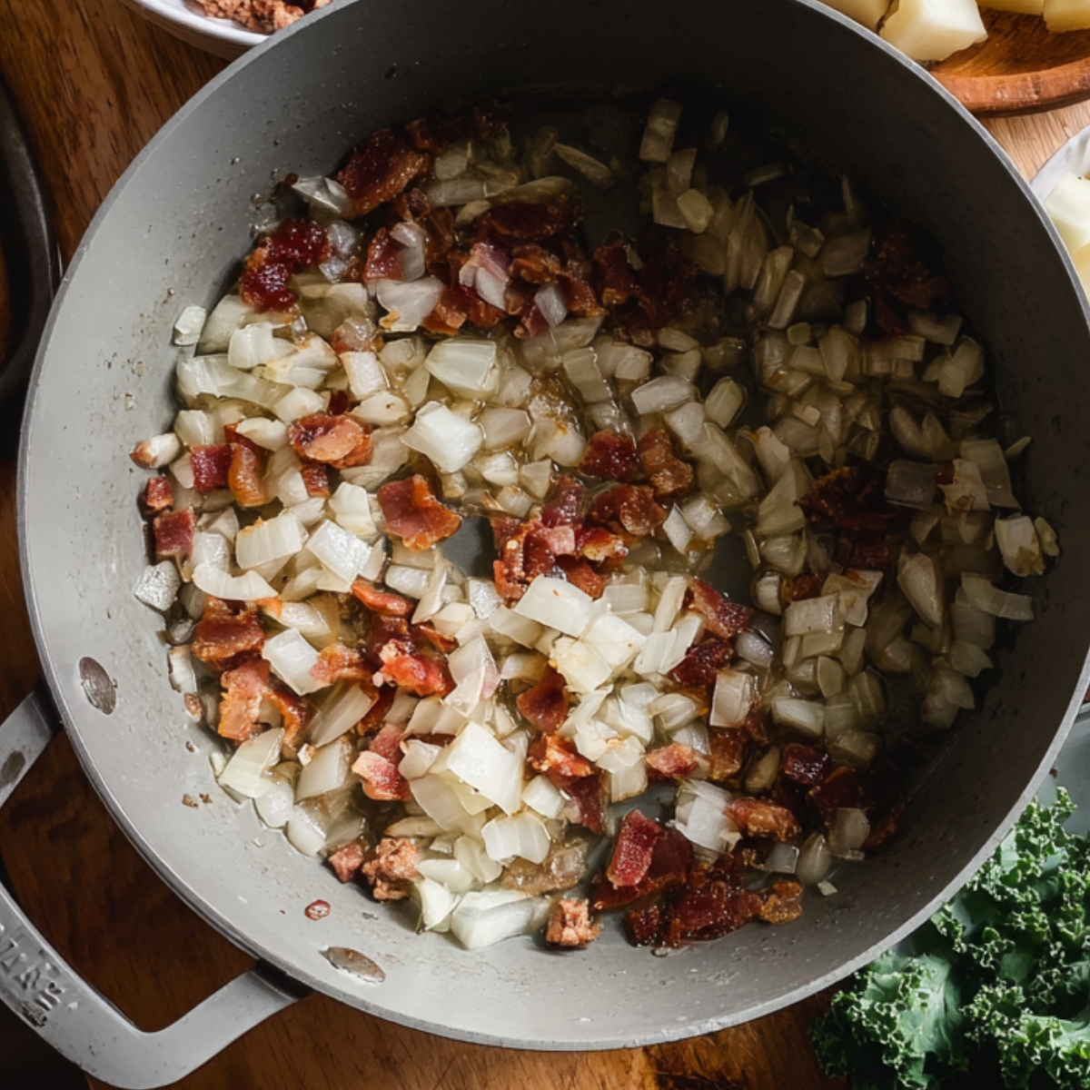 Close-up of chopped onions and crispy bacon cooking together in a pot, forming the base of a soup.